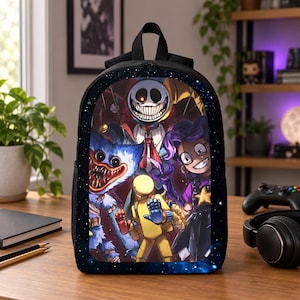 May include: A black backpack featuring a vibrant graphic print of various cartoon characters, including a blue furry creature with sharp teeth, a yellow figure, a purple-haired character, and a grinning jester-like figure against a starry background.