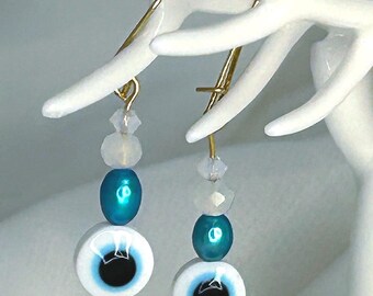 SImple, fun beaded evil eye earrings with aqua glass pearl, and semi-translucent crystal accents