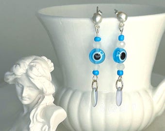 Dramatic beaded evil eye dangle earrings with silver, aqua, white and iridescent  glass accents