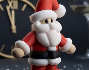 May include: A 3D printed Santa Claus figurine featuring a red suit with white trim, a black belt, and a matching red hat with a white pom-pom. The figure has a round beige face with two black eyes and a prominent white beard and mustache.