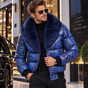 May include: A puffer jacket featuring a vibrant blue and black snakeskin pattern, a large dark blue faux fur collar, and black ribbed cuffs. The jacket is worn over a black turtleneck sweater, paired with black trousers and a silver wristwatch.