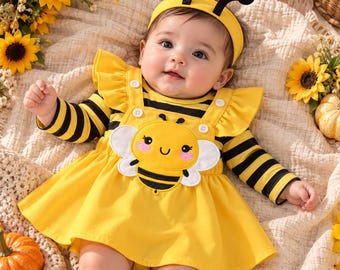 Eerste Halloween-outfit voor babymeisjes: romper met rokje en bijtje in de vorm van een lieveheersbeestje of bijtje.