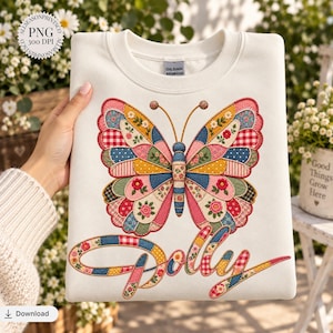 May include: A cream-colored crewneck sweatshirt featuring a large, colorful butterfly graphic composed of various patchwork patterns including floral, gingham, and polka dot designs. Below the butterfly, the word Dolly is written in a matching patchwork style.