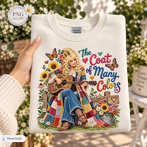 Könnte beinhalten: Ein cremefarbenes Sweatshirt mit Rundhalsausschnitt und einer grafischen Illustration einer blonden Person, die eine Akustikgitarre spielt, einen bunten Patchwork-Mantel und blaue Jeans trägt, umgeben von Sonnenblumen, Schmetterlingen und dem Text The Coat of Many Colors.