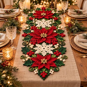 May include: A long, rectangular crochet table runner featuring a repeating pattern of vibrant red poinsettia flowers with gold centers, white snowflakes, green holly leaves, and small red and white berries, centered on a light brown fabric.
