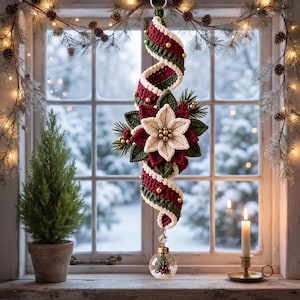 May include: A hanging crochet decoration featuring a spiraling ribbon in deep red and forest green, accented with gold beads. A central cream-colored poinsettia flower with green leaves is attached, and a clear glass bauble hangs from the bottom.