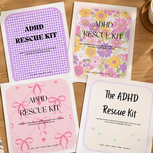 May include: Four rectangular ADHD Rescue Kit workbooks with distinct cover designs: one with a purple gingham pattern, one with a colourful floral print, one with pink bows and hearts, and one with a simple border and small hearts.