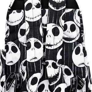 May include: Black backpack with a white and black pattern of Jack Skellington's face from The Nightmare Before Christmas. The backpack has adjustable straps with the Disney logo.