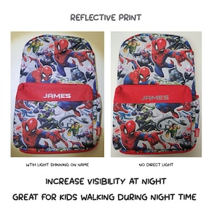 May include: A gray and white backpack with a red trim and a reflective print of Spider-Man and other Marvel characters. The backpack has a red pocket with the name "JAMES" printed on it. The backpack is shown in two images, one with light shining on the name and one with no direct light. The text "REFLECTIVE PRINT" is at the top of the image. The text "INCREASE VISIBILITY AT NIGHT" is below the images. The text "GREAT FOR KIDS WALKING DURING NIGHT TIME" is at the bottom of the image.