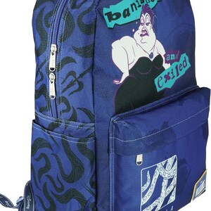 May include: A blue backpack with a black and white print of Ursula from Disney's The Little Mermaid. The backpack has a large pocket on the front with a zipper and a smaller pocket on the side. The text "banished and exiled" is printed on the front of the backpack.