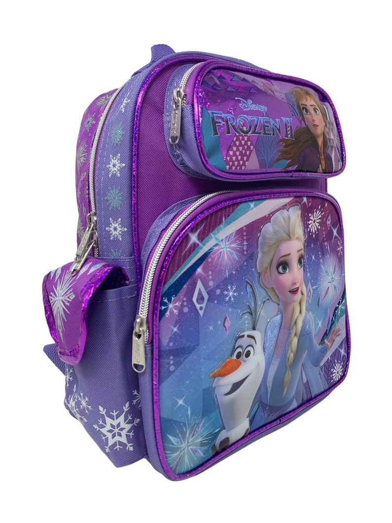 May include: Purple Frozen II backpack with a front pocket featuring Elsa and Olaf. The main compartment has a large image of Elsa and Olaf with a sparkly blue and purple background. The backpack has a side pocket with a snowflake design.