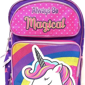 May include: Purple rolling backpack with a pink unicorn and rainbow design. The backpack has a pink handle and says "Always Be Magical" on the front.