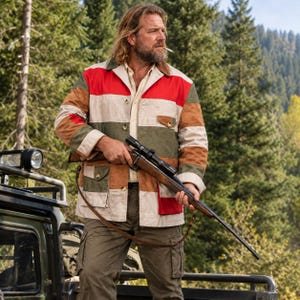 May include: A long-sleeve button-up jacket featuring horizontal stripes in red, white, olive green, and tan. The jacket includes a pointed collar, a front button closure, and two chest pockets with buttoned flaps. It is worn over a light shirt.