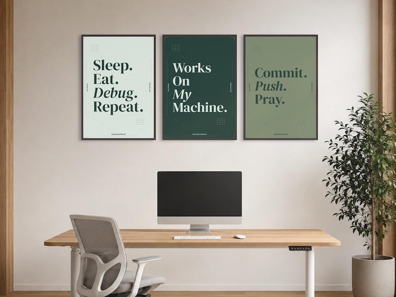 May include: Three framed wall art prints featuring dark green typography on light green, dark green, and sage green backgrounds. The text reads Sleep. Eat. Debug. Repeat., Works On My Machine., and Commit. Push. Pray. with small grid patterns.