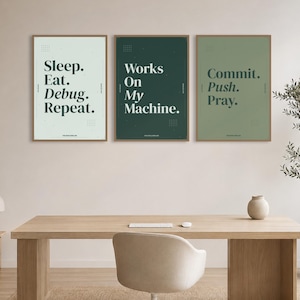 May include: Three framed wall art prints featuring dark green typography on light green, dark green, and sage green backgrounds. The text reads Sleep. Eat. Debug. Repeat., Works On My Machine., and Commit. Push. Pray. with small grid patterns.