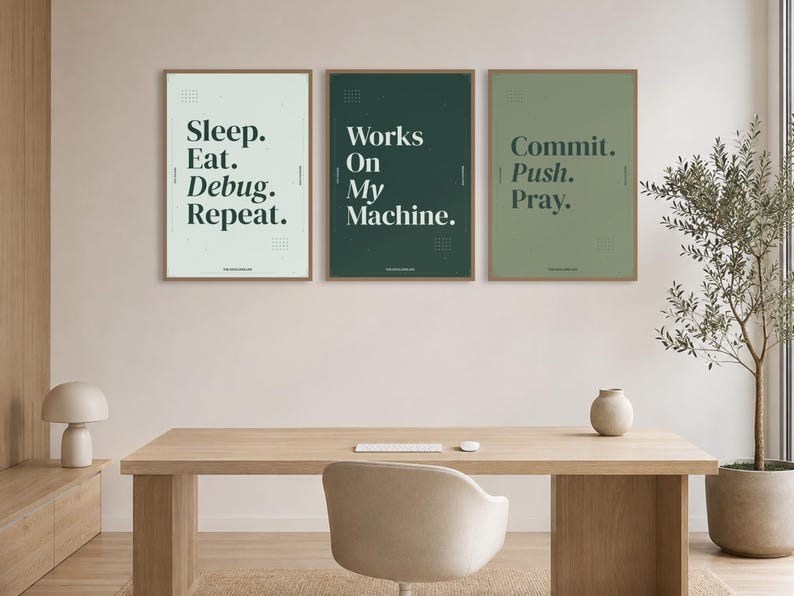 May include: Three framed wall art prints featuring dark green typography on light green, dark green, and sage green backgrounds. The text reads Sleep. Eat. Debug. Repeat., Works On My Machine., and Commit. Push. Pray. with small grid patterns.