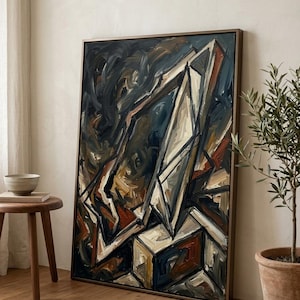 May include: A rectangular framed oil painting featuring abstract geometric shapes and angular lines in a palette of deep navy blue, charcoal gray, burnt orange, and cream. The composition displays thick, visible brushstrokes throughout.