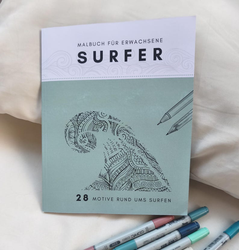May include: A softcover coloring book titled Malbuch f&uuml;r Erwachsene Surfer with a sage green cover featuring a black line art illustration of a stylized ocean wave. The cover includes the text 28 Motive rund ums Surfen and two pencil sketches.