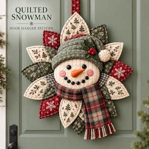 May include: A quilted snowman door hanger pattern featuring a central snowman face with a carrot nose, black button eyes and mouth, wearing a green quilted hat and a plaid scarf. The surrounding petals display red and green holiday prints.
