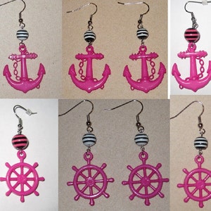 May include: A set of six pairs of pink and silver earrings. Each pair features a black and white striped bead and a pink charm. The charms are either an anchor or a ship's wheel.