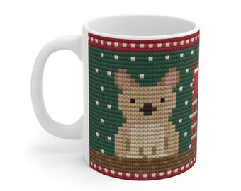 May include: A white ceramic mug featuring a printed design that mimics a green knitted sweater pattern. The graphic includes a tan dog, white dots, and red and white striped accents, creating a textured appearance on the mug surface.