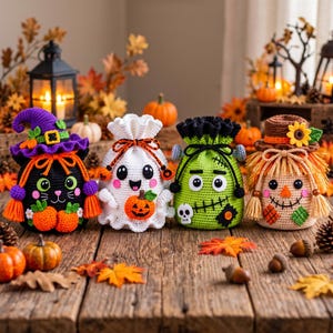 May include: Four crocheted drawstring bags featuring Halloween characters: a black cat with a purple witch hat, a white ghost holding a pumpkin, a green monster with a skull accent, and a scarecrow with a sunflower hat and straw-like fringe.