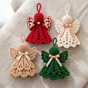 May include: Four crocheted angel ornaments in red, cream, beige, and dark green. Each angel features a round head, lacy wings, a flared skirt with a scalloped hem, a hanging loop, and a small wooden bead at the neck with a tied ribbon bow.