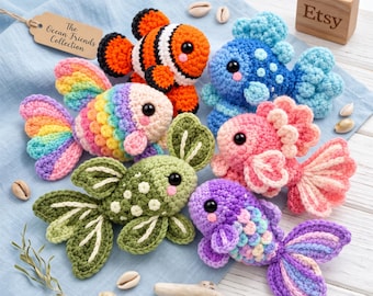 May include: A collection of six crocheted fish toys in various colors including orange, blue, pink, green, and purple, featuring black safety eyes and textured fins. A brown tag reads The Ocean Friends Collection and a wooden block is marked Etsy.