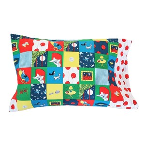 May include: A colorful pillowcase with a patchwork design featuring a cat, stars, and a lamp. The pillowcase is made of cotton and has a red, white, and blue color scheme.