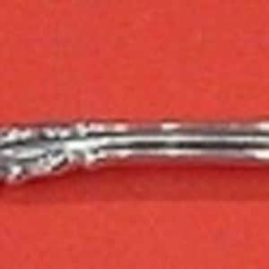 May include: A silver fork with a twisted handle and a decorative, fluted end. The fork has two prongs.
