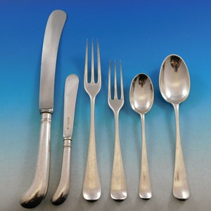 May include: A set of five silver-plated flatware pieces, including a butter knife, a dinner knife, a dinner fork, a teaspoon, and a soup spoon. The flatware has a simple, elegant design with a rounded handle.