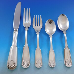 May include: A set of five silver-plated flatware pieces, including a knife, fork, and three spoons. The handles are ornate with a floral design.