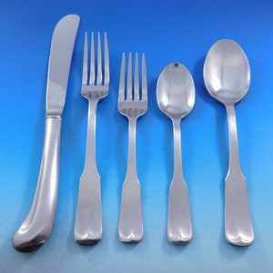 May include: A set of five silver-plated flatware pieces, including a knife, two forks, and two spoons. The pieces have a simple, elegant design with rounded handles.