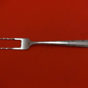 May include: A silver serving fork with a twisted handle and a decorative pattern on the handle.
