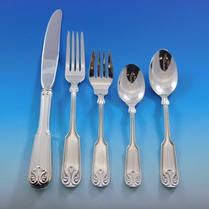 May include: A set of five polished silver utensils: a knife, two forks, a spoon, and a smaller spoon. Each piece has a decorative floral design at the base of the handle. The utensils are arranged against a gradient blue background.