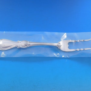 May include: A silver fork with a decorative handle and twisted tines, packaged in a clear plastic bag.