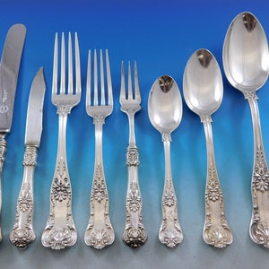 May include: A set of silver flatware with ornate handles. The set includes a knife, fork, and spoon.