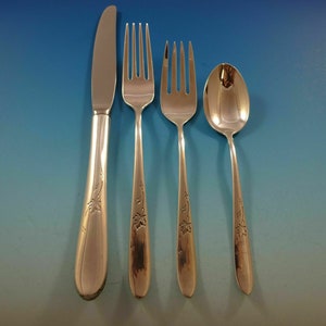 May include: A set of four silver-plated flatware pieces, including a knife, fork, teaspoon, and a larger fork. The pieces have a floral design on the handles.