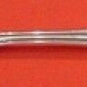 May include: A silver fork with a twisted handle and a decorative design on the handle. The fork is made of polished silver and has a classic design.