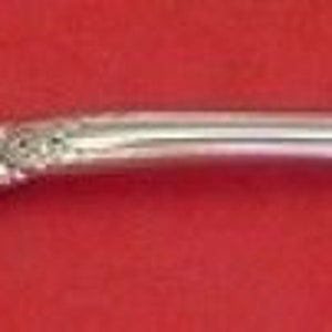 May include: A silver fork with a twisted handle and ornate design. The fork has two prongs and a decorative handle.