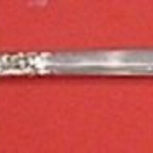 May include: A silver-plated serving fork with a twisted handle and a decorative floral design on the end.