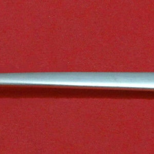 May include: A silver serving spoon with an ornate handle and a pierced bowl. The spoon is designed for serving ice cream or other desserts.