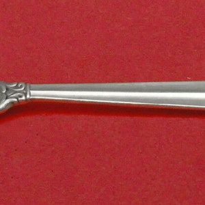 May include: A silver serving spoon with a decorative handle and a slotted oval bowl.
