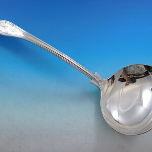 May include: A silver serving ladle with a decorative handle and a polished bowl.
