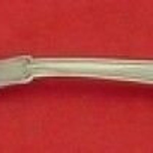 May include: A silver serving fork with a twisted handle and a decorative design on the back.