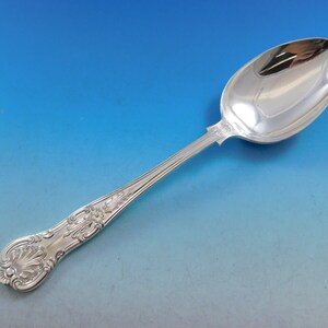 May include: A silver spoon with an ornate handle and a polished bowl. The handle features a detailed floral design.