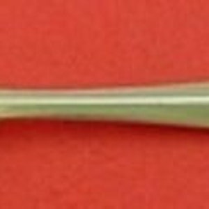 May include: Silver oyster fork with a twisted handle. The fork has two prongs and a rounded spoon-like end.