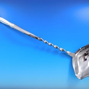 May include: A silver serving spoon with a twisted handle and a wide, rounded bowl. The spoon is polished to a high shine and has a classic design.