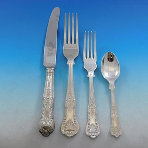 May include: A set of silver flatware, including a knife, fork, and spoon. The handles are ornate and feature a floral design.
