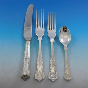 May include: A set of four silver-plated flatware pieces, including a knife, two forks, and a spoon. The handles are ornate and feature a floral design.